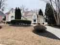 Elegant two-story brick house with lush landscaping, driveway, and mature trees at 8630 Moor Park Run, Duluth, GA 30097