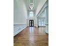 Grand foyer boasting hardwood floors, high ceilings, chandelier, and stylish entry doors at 8630 Moor Park Run, Duluth, GA 30097