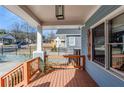 Inviting front porch featuring painted wood ceiling, wood decking, and decorative railing at 1057 Regent Sw St, Atlanta, GA 30310