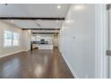 Spacious living room open to the kitchen featuring wood floors and exposed wood beams at 1057 Regent Sw St, Atlanta, GA 30310