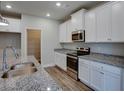 A kitchen showcasing granite counters, stainless steel appliances, and white cabinets at 3017 Abelia Dr, Buford, GA 30519