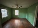 Bright bedroom with hardwood floors, two windows, and a classic ceiling fan at 3195 Benjamin E Mays Sw Dr, Atlanta, GA 30311