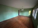 Spacious living room with hardwood floors, vintage chandelier, and large windows at 3195 Benjamin E Mays Sw Dr, Atlanta, GA 30311