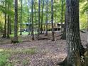 Wooded backyard featuring an elevated deck and peaceful scenery at 150 Melody Ln, Fayetteville, GA 30215