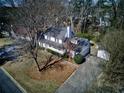 Aerial view of a lovely white house with mature trees and a long driveway at 1938 Kelvin Dr, Lawrenceville, GA 30043