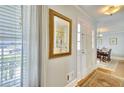 Bright entryway with a decorative mirror, hardwood floors, and a view of the dining area at 1938 Kelvin Dr, Lawrenceville, GA 30043
