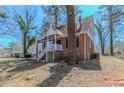 Exterior view of a classic brick home with inviting front porch and tree-lined yard at 238 Howell Sw Dr, Atlanta, GA 30331