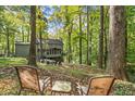 Secluded backyard with a patio and a firepit area, surrounded by lush trees at 275 Waverly W Trce, Roswell, GA 30075