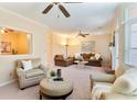 Spacious living room with plush seating, neutral decor, and multiple ceiling fans, creating a welcoming atmosphere at 312 River Glen Dr, Roswell, GA 30075