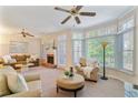 Inviting living room featuring a cozy brick fireplace, neutral tones, lots of light, and a ceiling fan at 312 River Glen Dr, Roswell, GA 30075