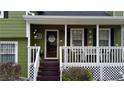 Inviting front porch showcasing decorative details and a cozy seating area, perfect for relaxing outdoors at 2102 Bedford Ct, Lithonia, GA 30058