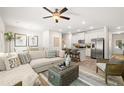 Open-concept living area with a large sectional sofa, kitchen with stainless steel appliances at 328 Sinclair Ct # 78, Mcdonough, GA 30253