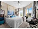 Cozy bedroom featuring a king-size bed, a desk area, and sliding doors to a private balcony at 1 Biscayne Nw Dr # 804, Atlanta, GA 30309