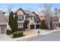 Charming brick two-story home with a well-maintained lawn, a two-car garage, and appealing curb appeal at 230 Society St, Alpharetta, GA 30022