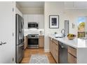 Bright kitchen boasts stainless steel appliances, stone countertops, and wood flooring at 384 Ralph Mcgill Ne Blvd # 314, Atlanta, GA 30312