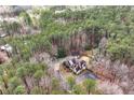 Aerial view of a private home nestled among lush greenery and mature trees on a spacious lot at 2557 Sixes Rd, Canton, GA 30114