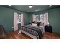 Cozy bedroom with hardwood floors, two windows, and designer green paint at 2569 Woodhill Ln, Atlanta, GA 30344