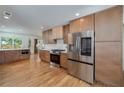 Modern kitchen boasting stainless steel refrigerator, hardwood floors, and custom cabinets with ample storage at 2569 Woodhill Ln, Atlanta, GA 30344