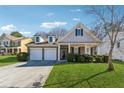 Beautiful home showcasing a lush green lawn, a two-car garage and inviting front entrance at 6491 Stonelake Sw Pl, Atlanta, GA 30331