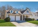 Inviting two-story house with a manicured lawn and attached two-car garage, exuding curb appeal at 6491 Stonelake Sw Pl, Atlanta, GA 30331