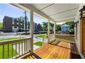 Inviting front porch boasts wood flooring, white railings, and a great view of the neighborhood at 891 Thurmond Nw St, Atlanta, GA 30314