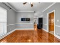 Bright living room with hardwood floors, light gray walls, and views into the kitchen and other rooms at 1450 Brandy Shoals Se Dr, Conyers, GA 30013