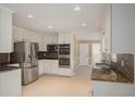 Modern kitchen with stainless steel refrigerator, built-in microwave and oven, and granite counters at 4837 Mystere Cir, Lilburn, GA 30047