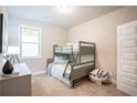 Cozy bedroom with a bunk bed, desk, and patterned ottoman at 2130 Manor Pointe Dr, Cumming, GA 30041