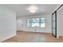 Bright living room featuring gleaming hardwood floors, fresh white paint, and an elegant sliding barn door at , Atlanta, GA 30329