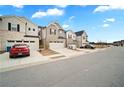 Charming townhomes featuring attached garages, driveways, and manicured lawns under a blue sky at 1120 Sunny Lake Dr, Lawrenceville, GA 30043