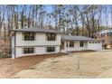 Charming two-story home with a combination of white brick and siding, surrounded by mature trees at 2490 Brookcliff Ne Way, Atlanta, GA 30345