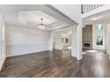 Spacious living room with dark wood floors, decorative trim, and a view to the living room with stone fireplace at 314 Lake Bluff Ct, Suwanee, GA 30024