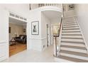 Bright foyer with staircase, white trim and tile floors at 9570 Huntcliff Trce, Atlanta, GA 30350