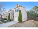 Side view of the townhome displaying the well maintained lawn and siding at 556 Oakside Pl, Acworth, GA 30102