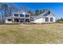 Beautifully landscaped two-story white home with a covered front porch and well-maintained lawn at 684 Old Cumming Rd, Sugar Hill, GA 30518