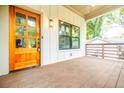 Cozy porch features a stained wood door, modern lighting, dark trim windows and craftsman-style railing at 353 Troy Se St, Atlanta, GA 30315