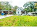 Beautifully renovated house with expansive lawn and craftsman details on porch, situated on treed lot at 353 Troy Se St, Atlanta, GA 30315