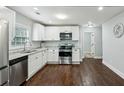 Modern kitchen with stainless steel appliances, granite countertops, and white cabinets at 3261 Lowndes St, Atlanta, GA 30337