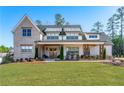 Beautiful home with a large front yard, covered porch, and classic architectural details at 39 Telfair Ct, Acworth, GA 30101