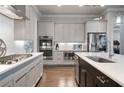 Modern kitchen featuring stainless steel appliances, light countertops, and ample cabinet space at 10570 Grandview Sq, Johns Creek, GA 30097