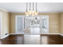 Spacious living room with hardwood floors and a modern chandelier at 3911 Ivy Ne Rd, Atlanta, GA 30342
