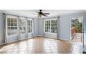 Bright sunroom with tile flooring and large windows overlooking the backyard at 3911 Ivy Ne Rd, Atlanta, GA 30342