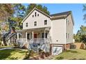 Beautifully renovated two-story home featuring a welcoming front porch and garage at 1819 Avon Ave, Atlanta, GA 30311
