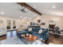 Spacious open concept with hardwood floors, exposed beam, and seamlessly connects the living, dining, and kitchen areas at 1888 Colt Dr, Atlanta, GA 30341