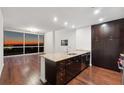Modern kitchen with stainless steel appliances, dark cabinets and a large island with granite countertops at 3325 Piedmont Ne Rd # 1504, Atlanta, GA 30305