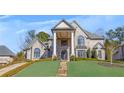 Elegant two-story brick home with meticulously landscaped front yard and a grand, pillared entrance at 426 Lanesborough Dr, Marietta, GA 30064