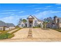 Beautiful two-story home featuring a grand entrance, arched windows, and meticulously maintained landscaping at 426 Lanesborough Dr, Marietta, GA 30064