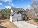 Charming two-story home with a well-manicured lawn and a two-car garage at 237 Elmbrook Ln, Canton, GA 30114