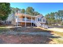 Charming home with a covered porch, two-car garage, and spacious front yard at 26 Wey Bridge Ct, White, GA 30184