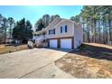 Charming home with a covered porch and a driveway leading to a two-car garage at 26 Wey Bridge Ct, White, GA 30184